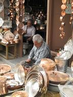 old man making dishes