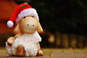 figurine of a sheep in a christmas hat