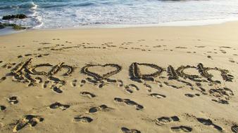 sweet love lettering in the sand