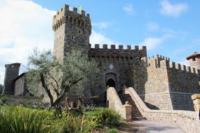 stone castle with a tower under the blue sky