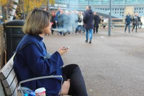 smoking woman with smartphone