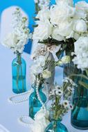 glass blue vases with white flowers