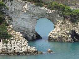 sea view with a stone arch