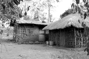 huts in a village in uganda in black and white background