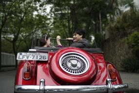 the happy couple in the red car