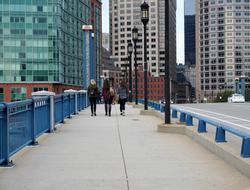 people walk on a bridge in Boston