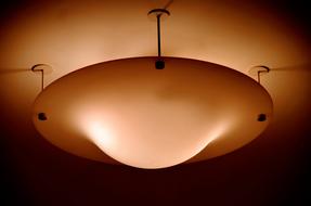 round orange lamp on the ceiling