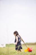 photo of asian girl with toy on the field