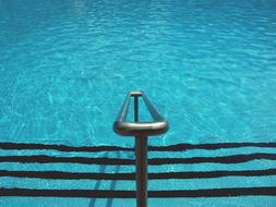 iron railings at the stairs leading to the pool