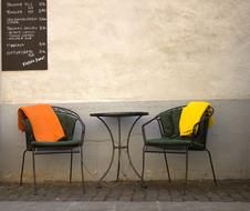 two Chairs and table at wall