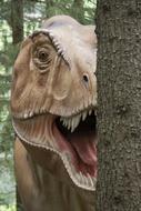 rex sculpture behind the tree