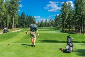 people playing golf on the course