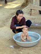 girl bathes a cute baby