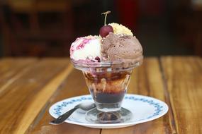sweet ice cream in a glass with a berry