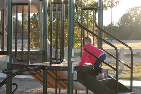 little girl on the playground on a sunny day