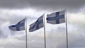 Finnish flags against the clouds