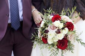 Wedding couple with a bouquet of flowers