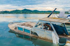 old rusty boat in the lake