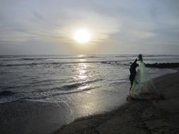 Fisherman on sea coast