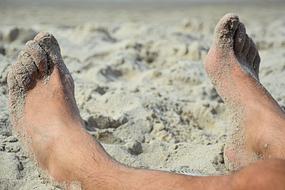 Feet on sand Beach closeup photo