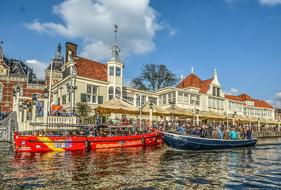 photo of bright tourist boats on a canal in Amsterdam