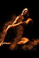 erotic photo of a girl and golden sand