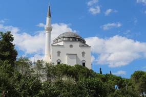 white mosque among green trees in Istanbul, Turkey