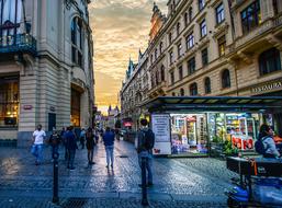 Beautiful and colorful street of Prague with people, at colorful twilight, in Czech Republic