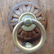 gold handle on a wooden door