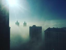towers of buildings in the fog
