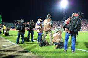 photojournalists on the edge of a soccer field