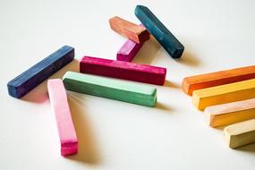 multicolored crayons on a white table