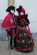man and girl in carnival costumes