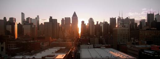 sun setting behind the towers