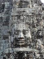 a man's face on a stone wall