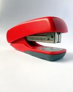 red office stapler on a white background