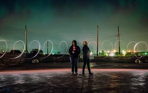 girls against the backdrop of a swirling glow
