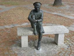 French sculpture of a boy on a bench