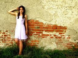 girl in a white dress near the wall