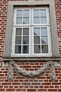 decor under the windows of an old brick building