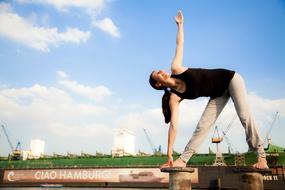 girl doing yoga in front of the ship port