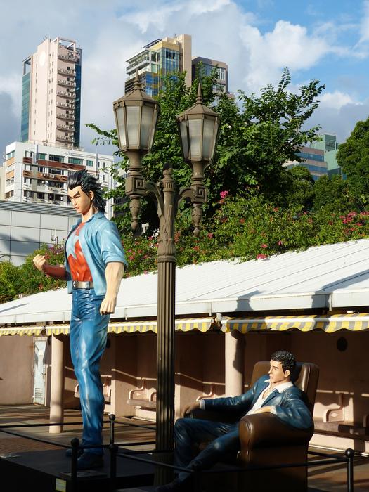 Colorful figures near the lantern, in the park of Kowloon, Hong Kong, among the colorful buildings