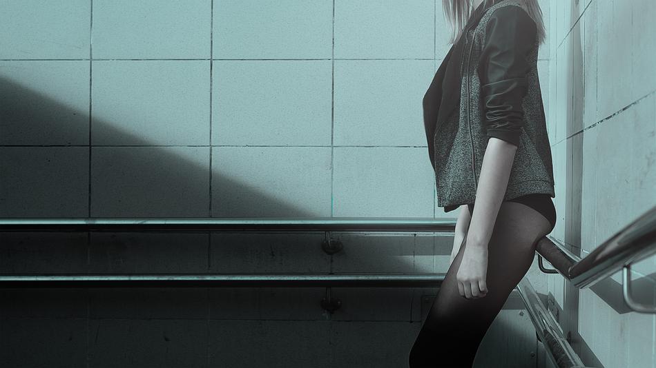 Girl In Pantyhose leaning on railing at wall