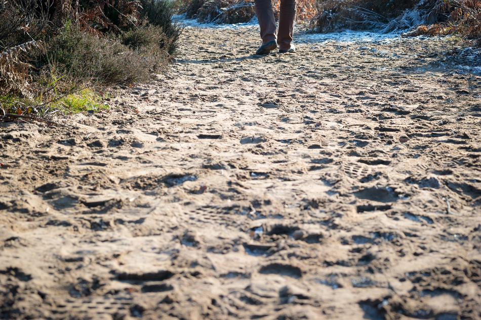 man walks on a sandy beach