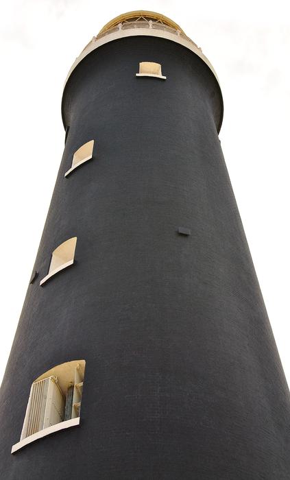 black lighthouse on a white background