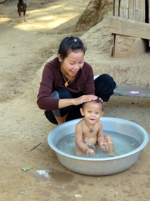girl bathes a cute baby