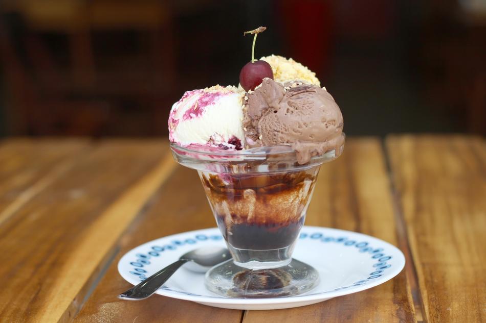 sweet ice cream in a glass with a berry
