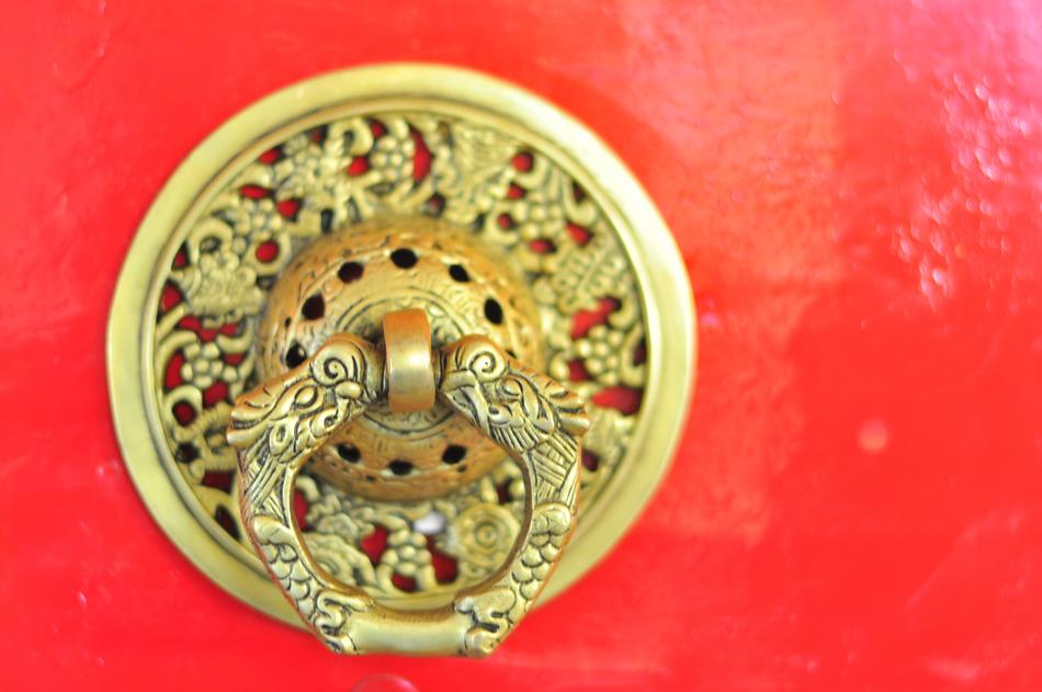 gold handle on a red door