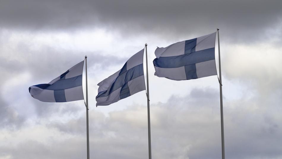 Finnish flags against the clouds