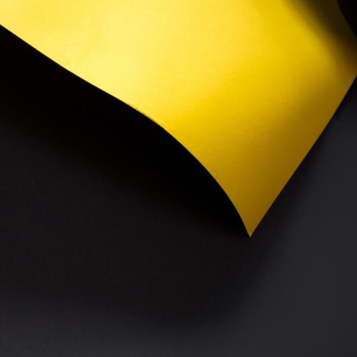 Yellow curled sheet at Black background